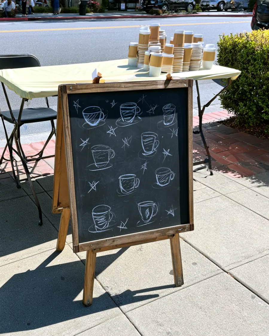 A chalkboard menu sign at the coffee pop up